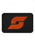 Trainimals Pflatsch Klett-Patch in Schwarz mit orangefarbenem gesticktem Logo aus Twill-Gewebe